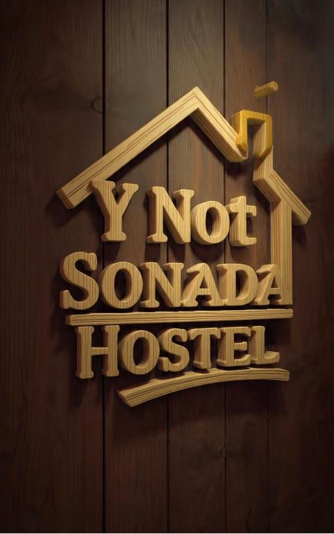 a sign that says notvard house on a wooden wall at Y Not Sonada in Sonāda