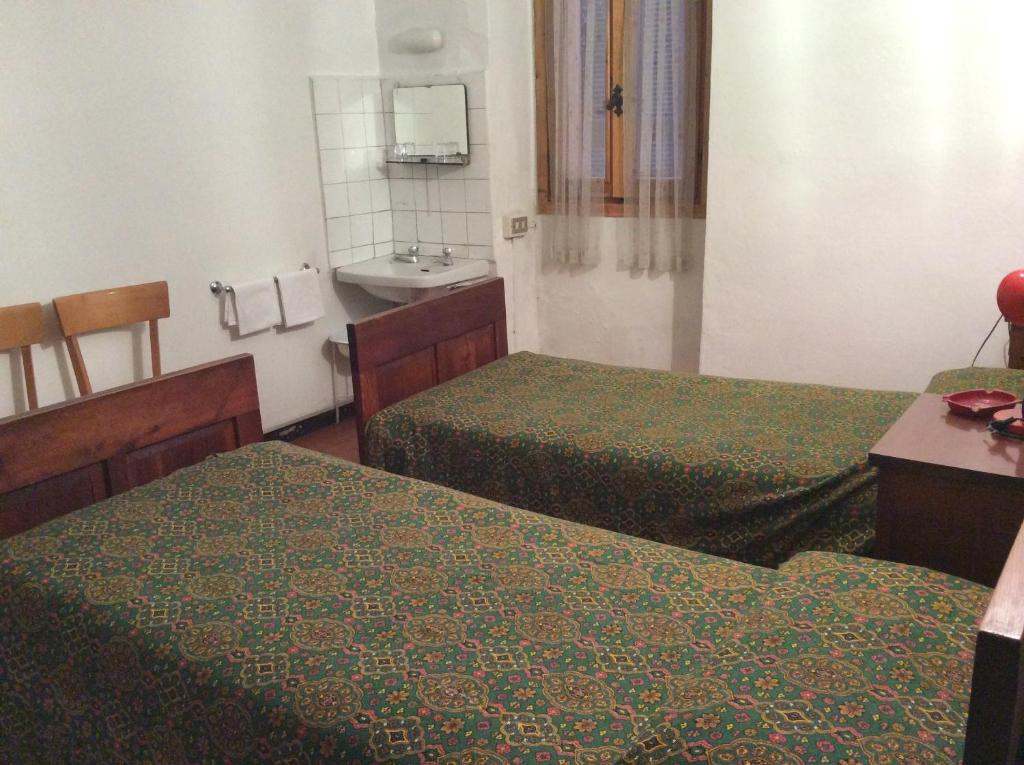 Postel nebo postele na pokoji v ubytování Albergo Cervo