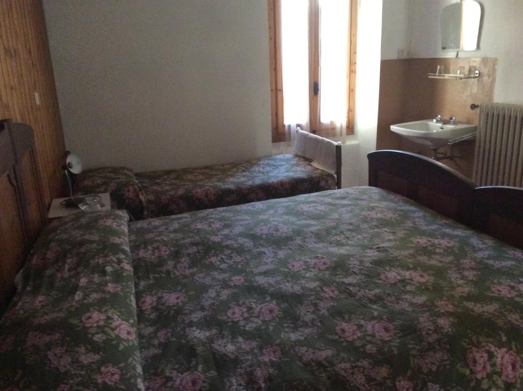 Postel nebo postele na pokoji v ubytování Albergo Cervo