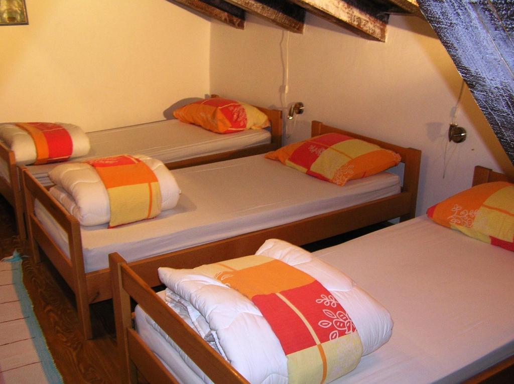 Pliskovica的住宿－普里斯克維卡青年旅舍，客房设有三张双层床和色彩缤纷的枕头。