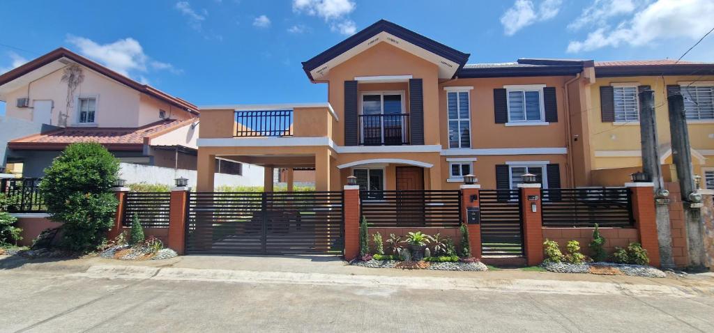 a house with a fence in front of it at Nicholas Residence in Silang