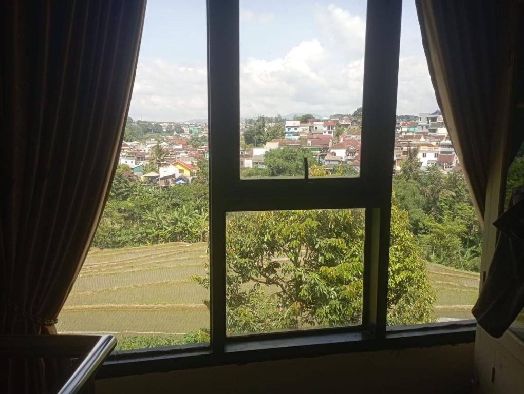 a window with a view of a city at Cozy stay wsb in Wonosobo