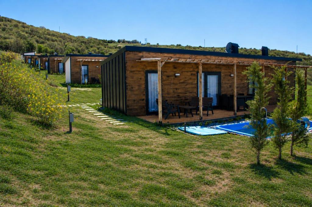 a house with a swimming pool in a field at Loft Orman Tatil Köyü in Ankara