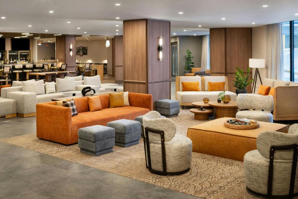 a lobby with couches and chairs in a hotel at Delta Hotels by Marriott Halifax Downtown in Halifax