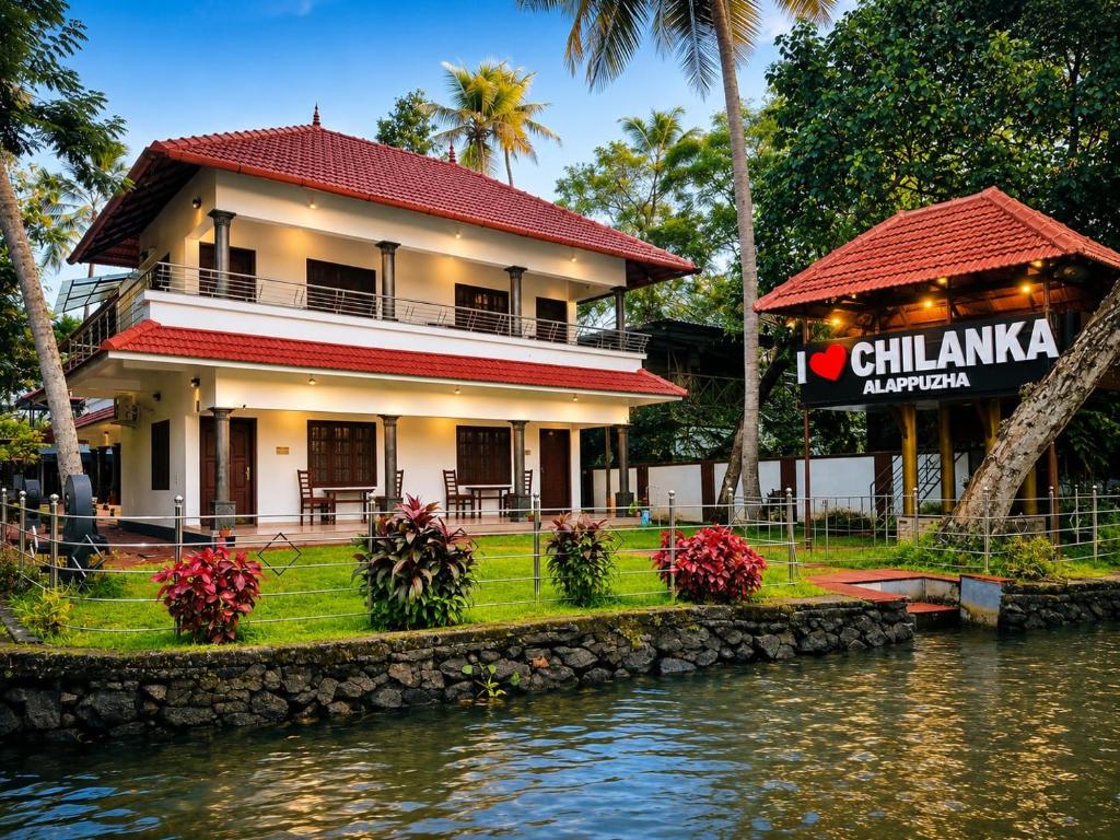 a building next to a body of water at Chilanka Lake View Resort in Alleppey