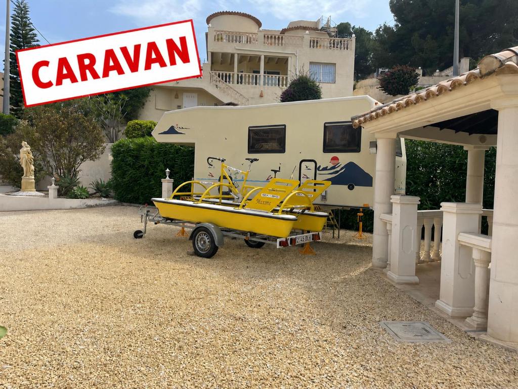 a yellow boat parked in front of a house at Casa Elite in Calpe