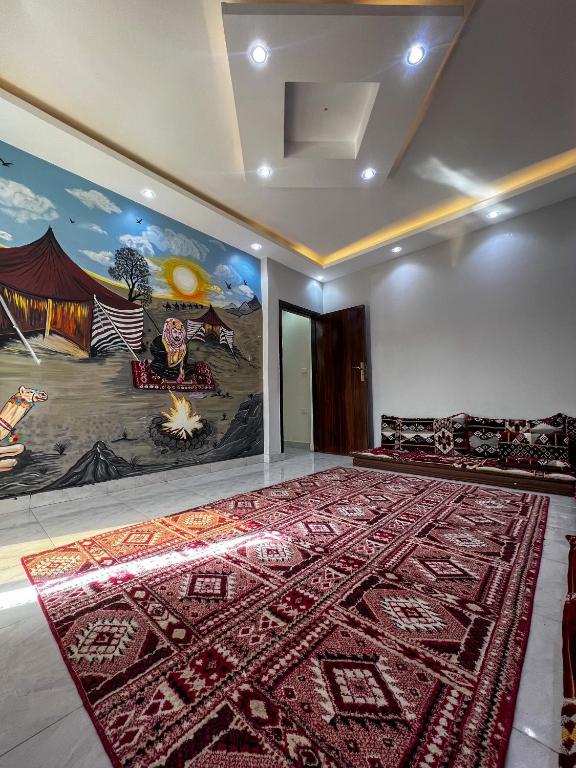 a room with a large rug on the wall at عماره in Sheikh Zayed