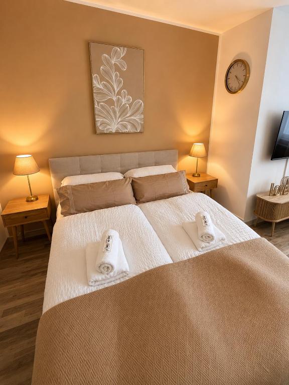 a bedroom with a large bed with towels on it at Ferienwohnung Rehn 2 in Bad Kissingen
