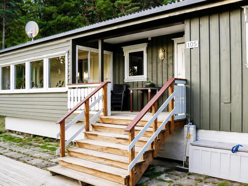 a tiny house with stairs leading to the front door at 6 person holiday home in Flatanger in Lauvsnes