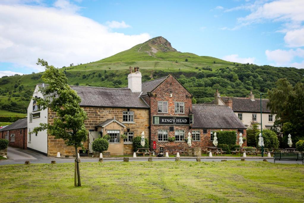 an inn with a mountain in the background at The King's Head Inn - The Inn Collection Group in Great Ayton