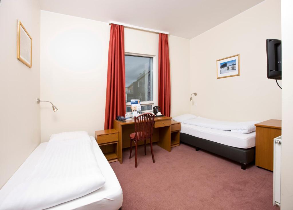 Postel nebo postele na pokoji v ubytování Fosshotel Baron