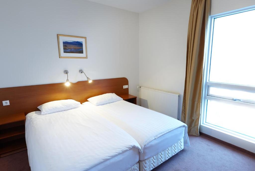 Postel nebo postele na pokoji v ubytování Fosshotel Baron