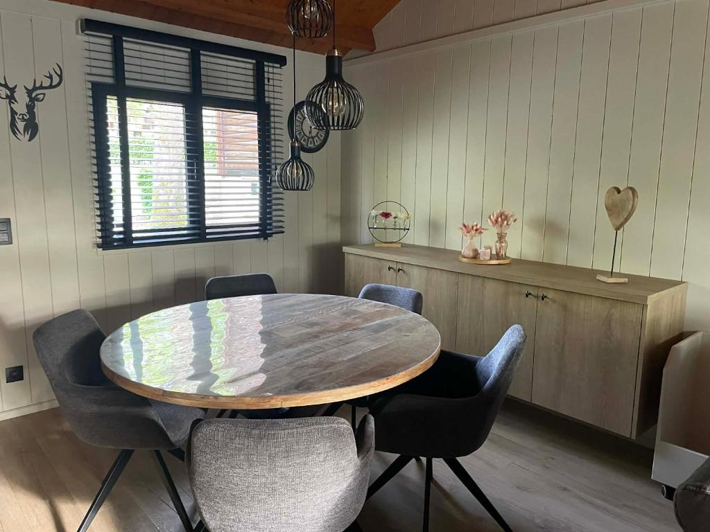a dining room with a wooden table and chairs at Natuur, Rust & Ontspanning in de Ardennen in Rendeux