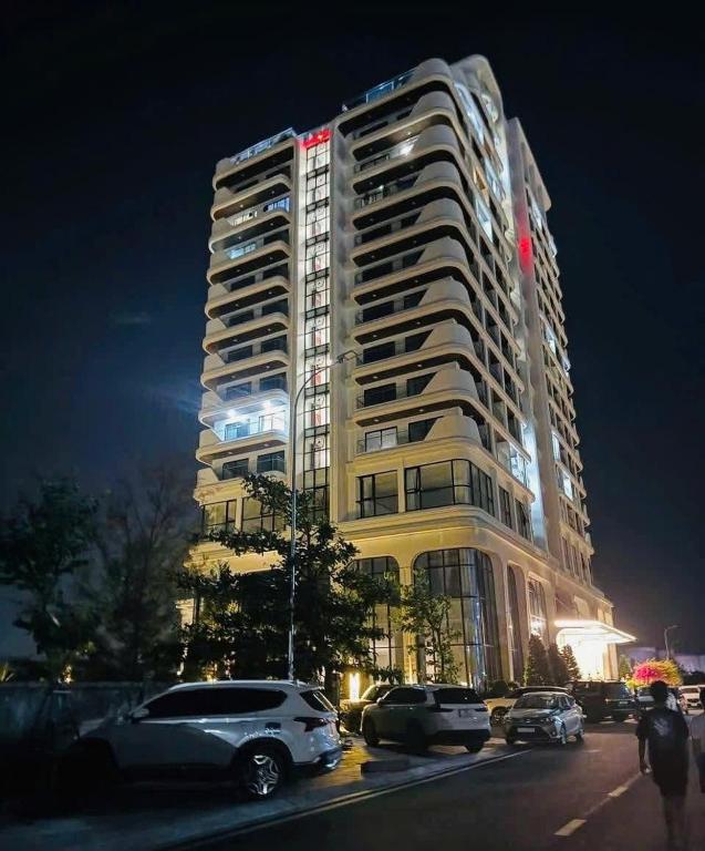 a tall building with cars parked in front of it at Khách sạn LAzur Cửa Lò- Nghệ An in Giáp Vinh Yên