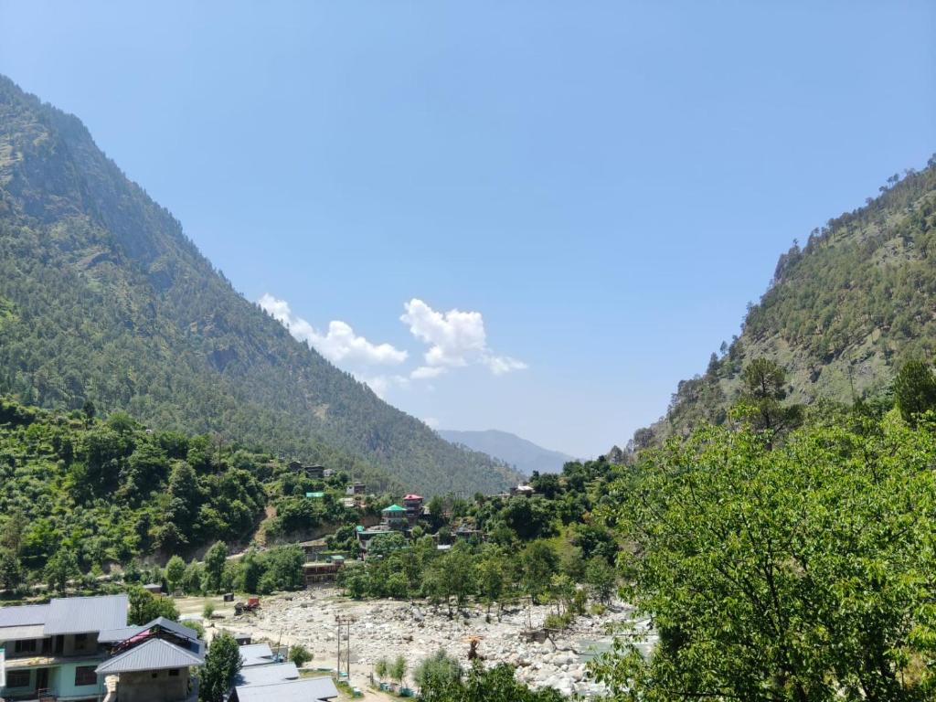 a view of a valley in the mountains at The Morchella House Tirthan Valley in Gushaini