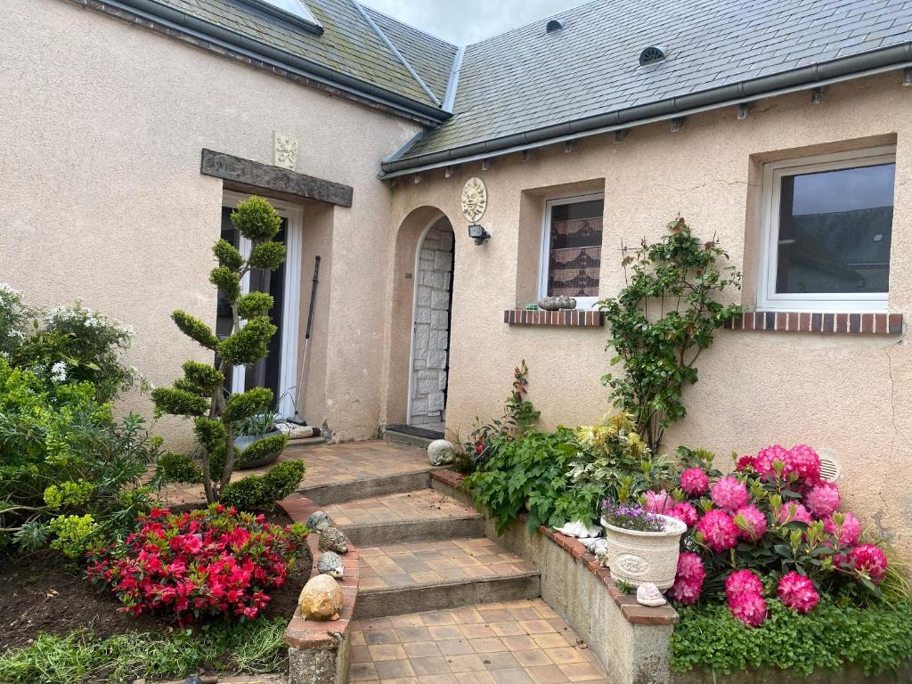 a house with flowers in the front yard at Arlette Guest House in Essarts