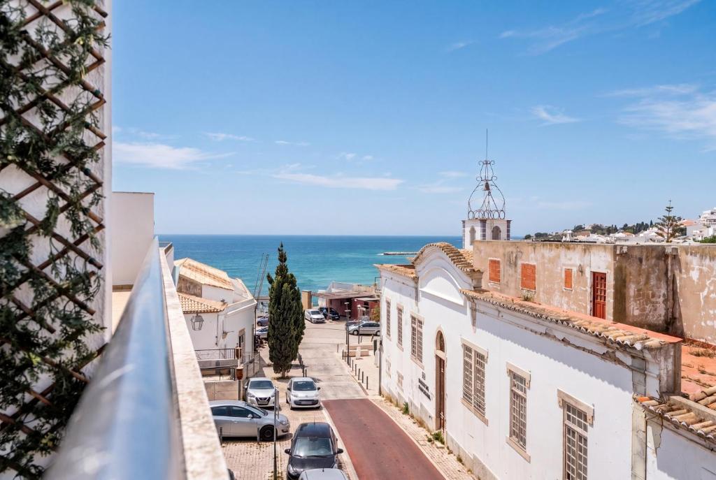 a view of a street in a town with the ocean at Albufeira prime stay in Albufeira