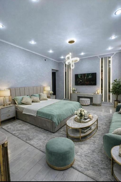a bedroom with a large bed and a living room at Taraz in Taraz