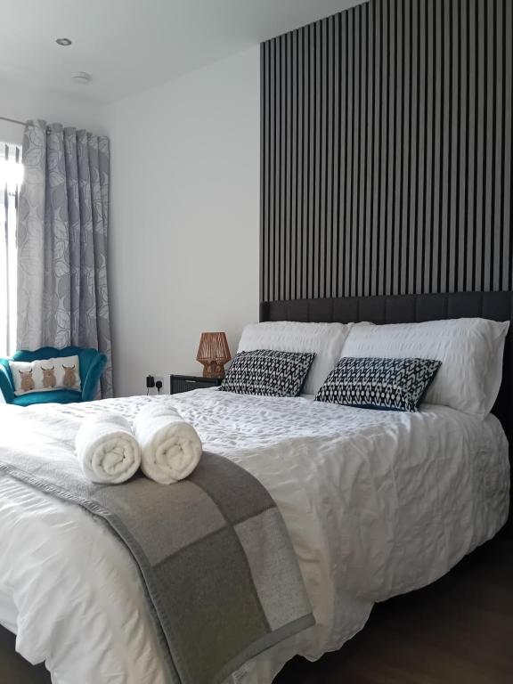 a bedroom with a large bed with towels on it at The Snug on The Brae in Inverness
