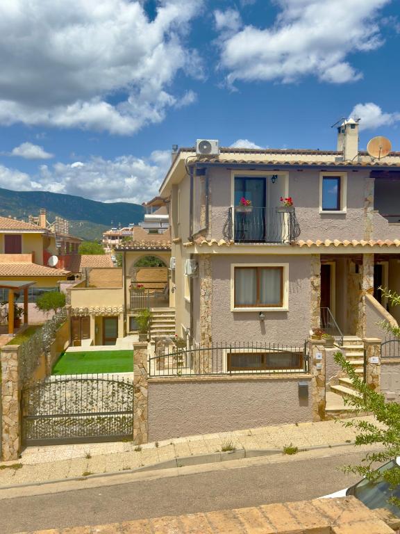 a house with a balcony with a yard at Elyas Guest House in Villasimius