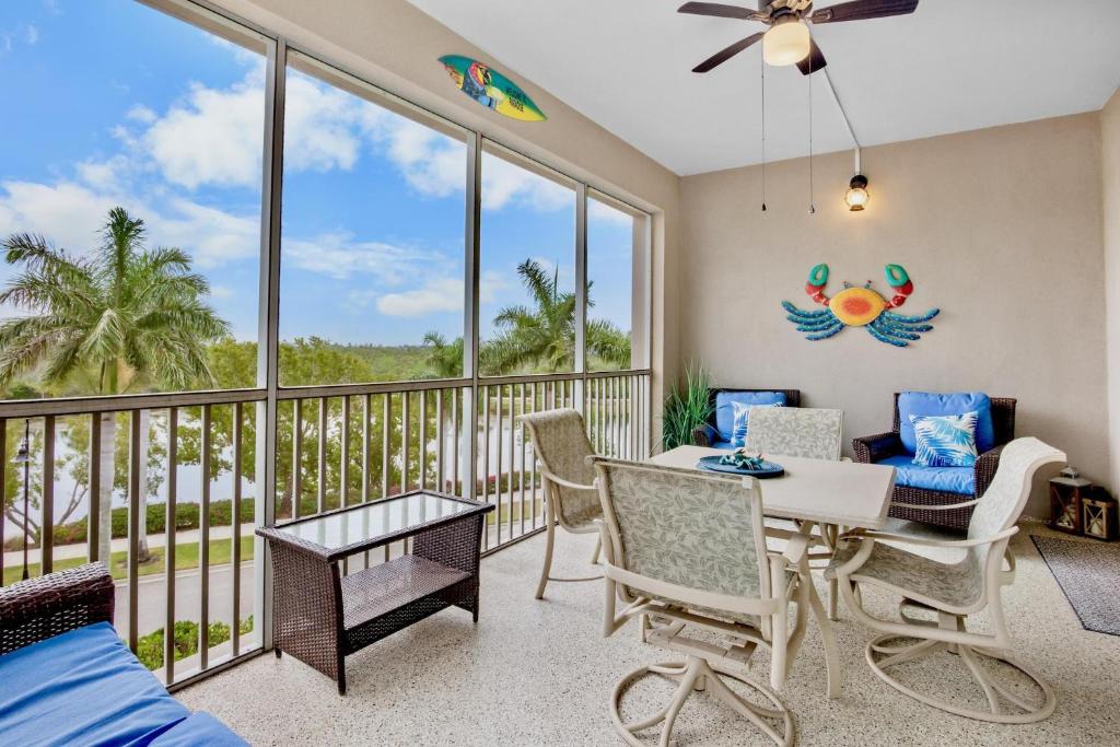 a living room with a balcony with a table and chairs at One Happy Condo in Bradenton