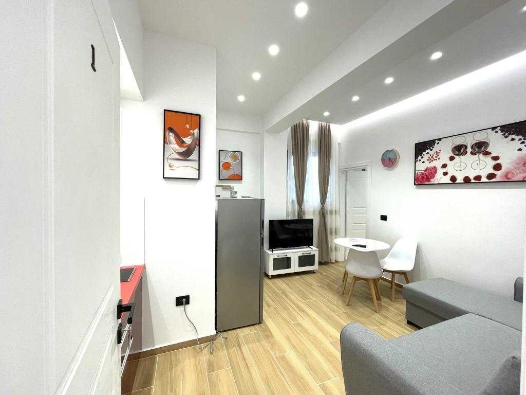 a white apartment with a kitchen and a living room at Vila KAM in Vlorë