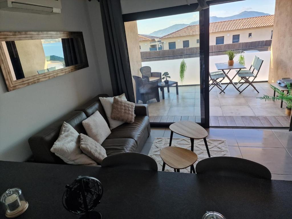 a living room with a couch and a table at T2 cozy vue mer in Pietrosella