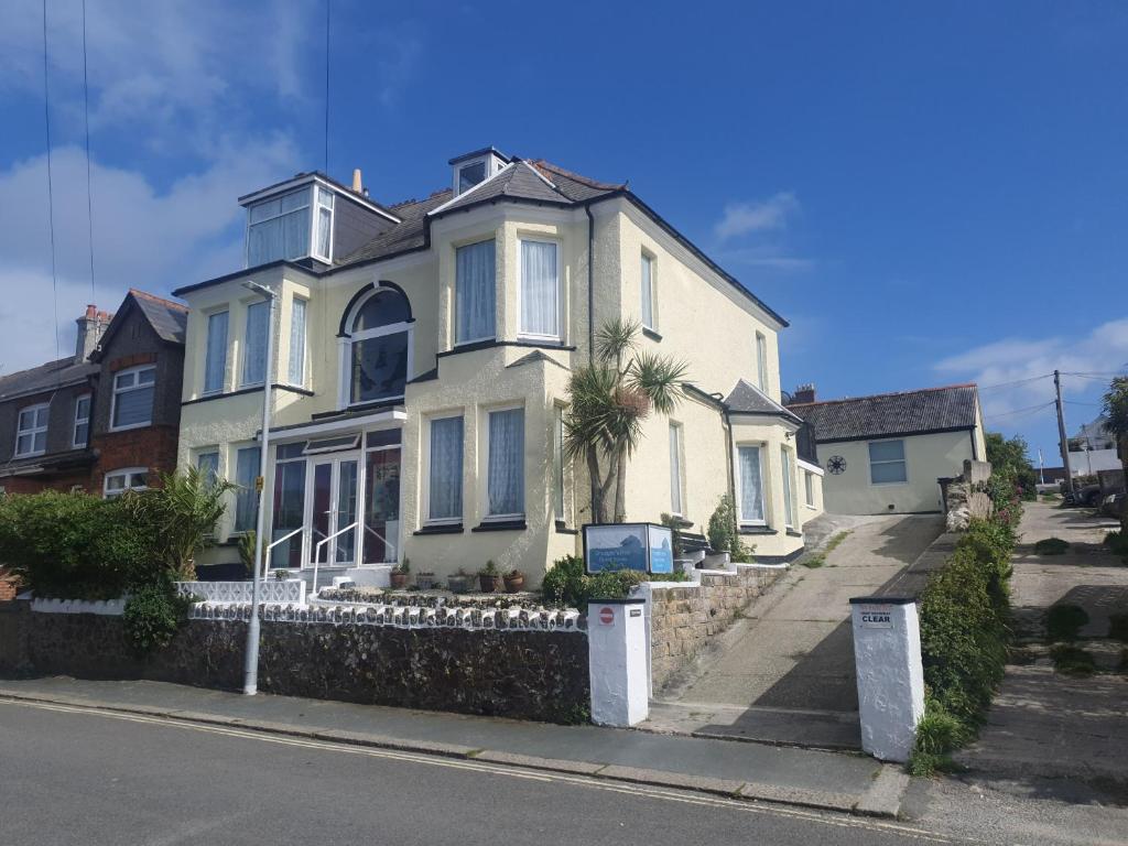 a large white house on the side of a street at Smugglers Rest in Newquay