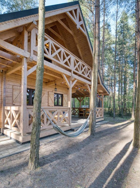 a wooden cabin in the woods with trees at Na Las Czas in Sompolno