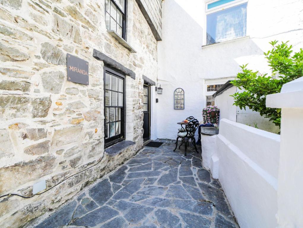 a stone walkway in front of a building at Miranda Cottage in Polperro