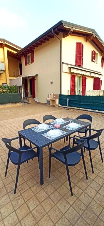 two picnic tables and chairs on a patio at Lake Iseo Apartment - Taxo4 in Paratico