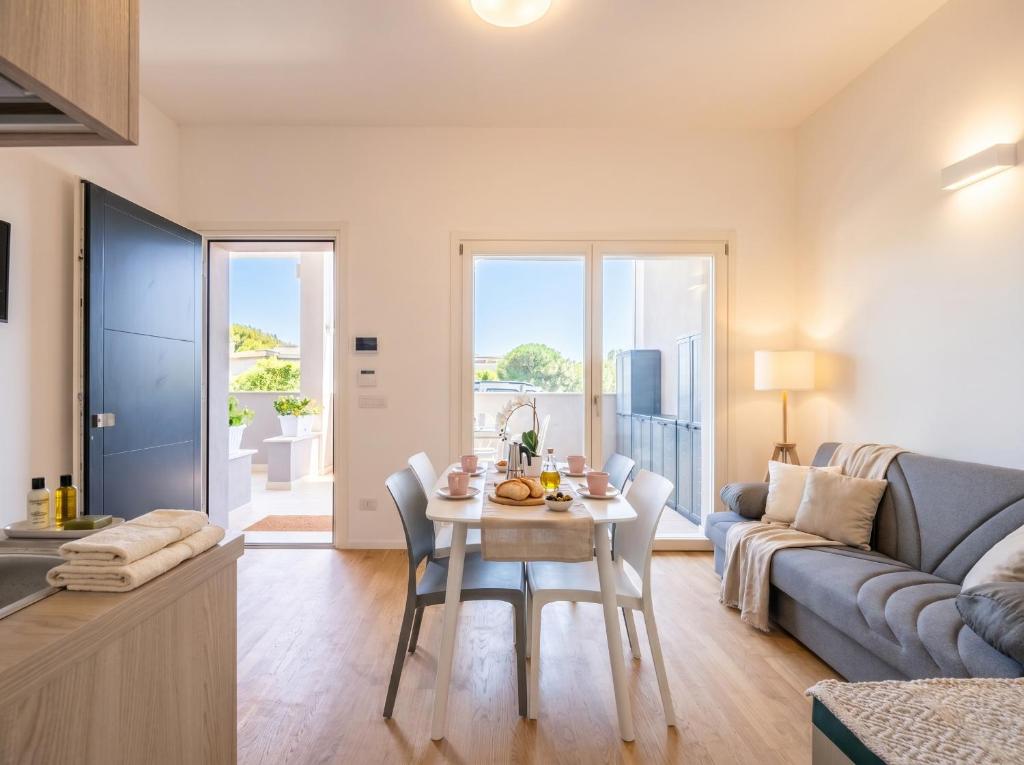 a kitchen and living room with a table and a couch at Dimora Anna - Exclusive Sea Loft in Bari