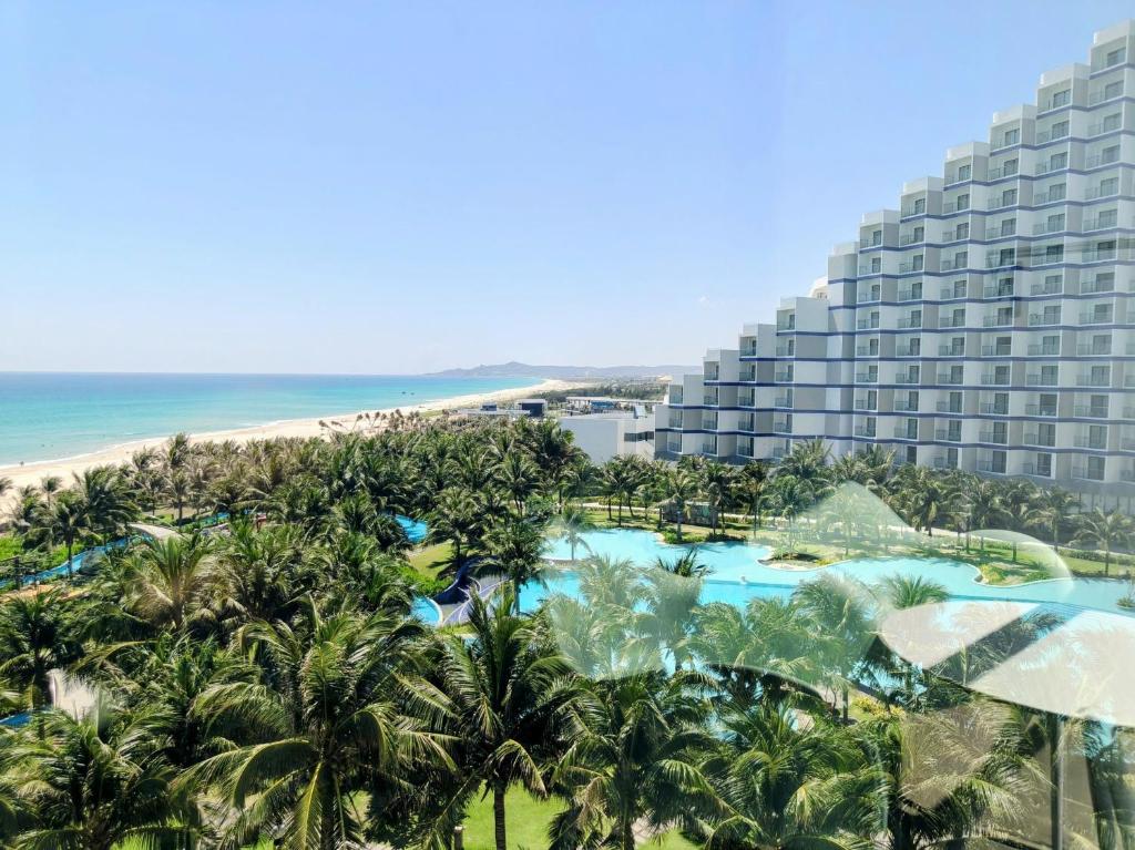 an aerial view of a resort with a pool and the beach at Oceanview Apartment at Arena Cam Ranh Resort in Thôn Hòa Ða