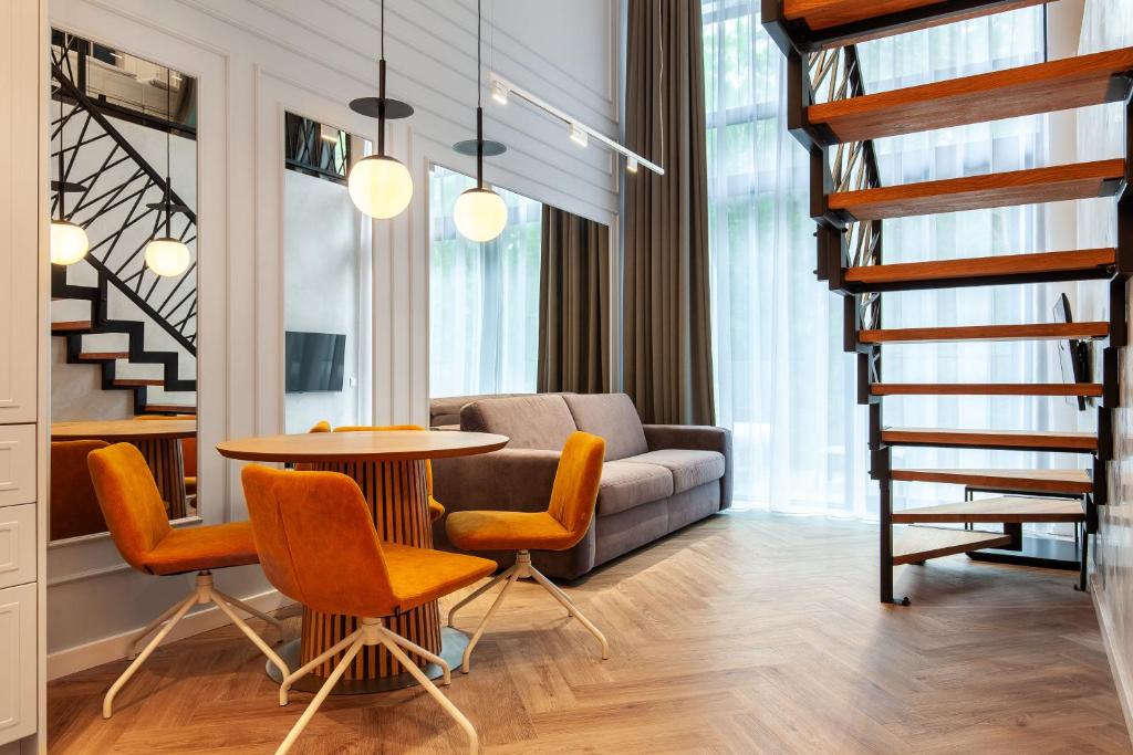 a living room with a table and chairs and a couch at Amber Elite Apartments in Stegna