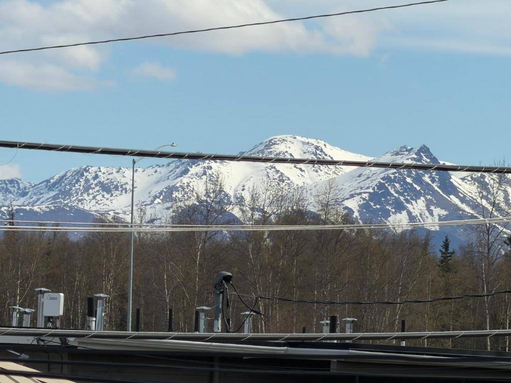 a view of snow covered mountains from a bus window at Cozy Place in Anchorage