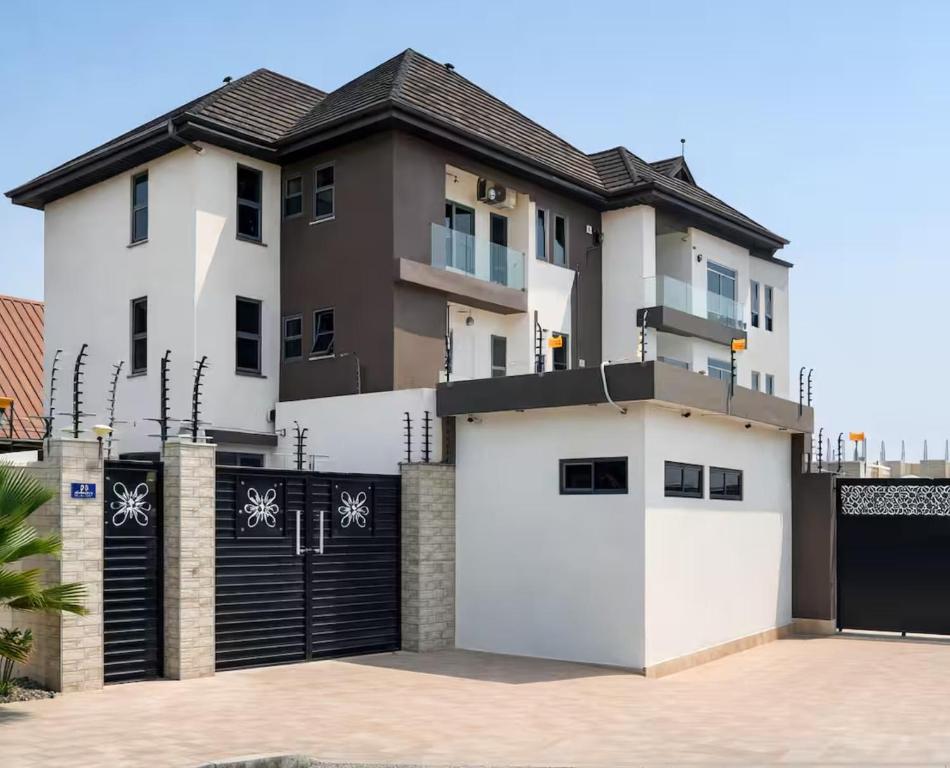 a house with two white garage doors in front of it at Pinnacle Apartment Lekki in Lekki
