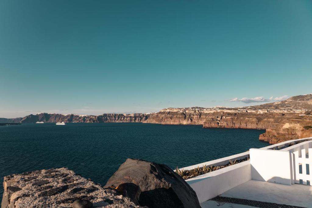 a view of a body of water with cliffs at Epic View Suites in Akrotiri