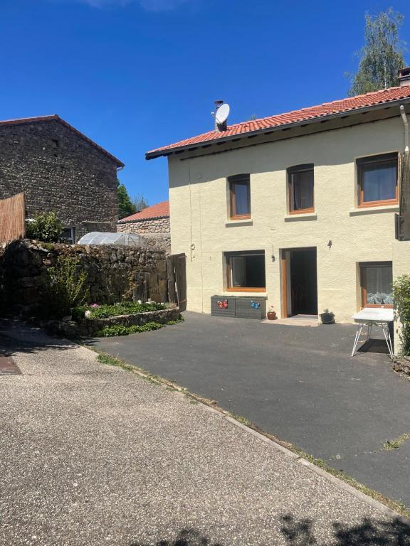 a house with a parking lot in front of it at La Salamandre in Valprivas