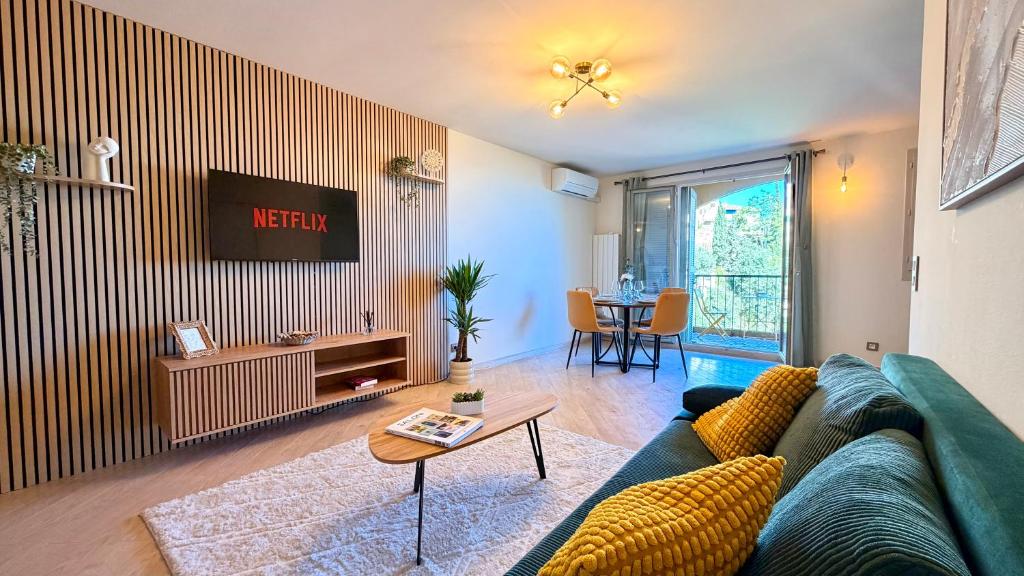 a living room with a blue couch and a table at Riviera Heights Monaco in Beausoleil