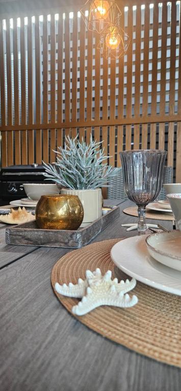 a wooden table with plates and dishes on it at Doris in Pakoštane