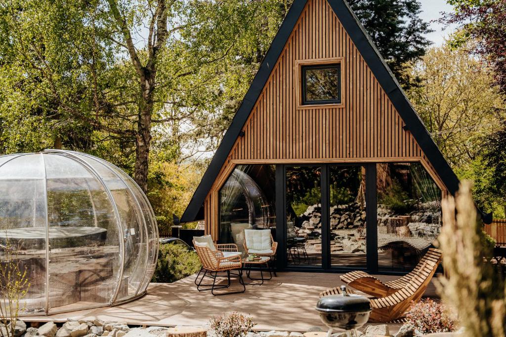 a gazebo with chairs and a glass dome at Maroska Pine in Kismaros