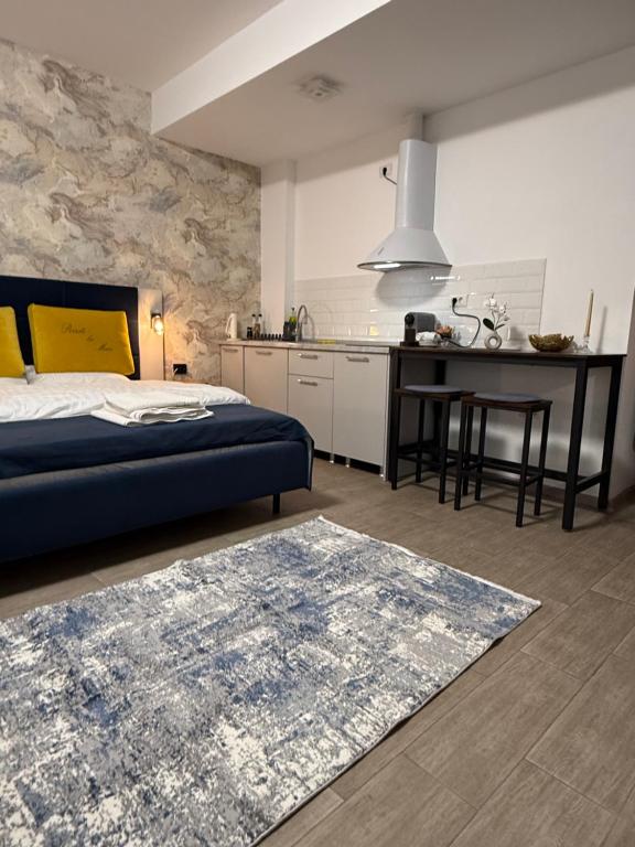 a bedroom with a bed and a table and a kitchen at Studio Matias 2 Casa Del Mar in Mamaia