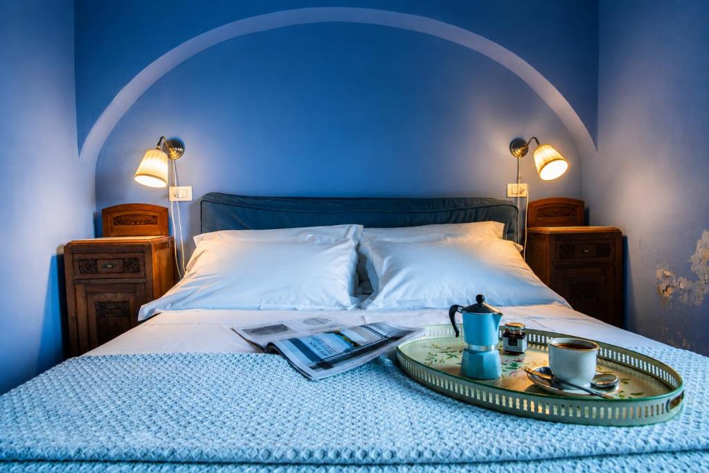 a bed with a tray of food on top of it at Casa D'aria in Catania