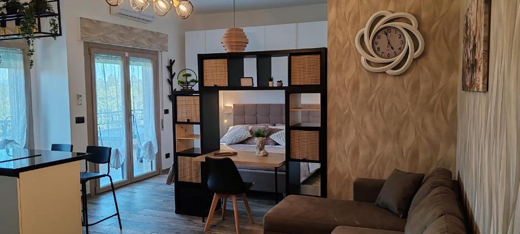 a living room with a couch and a desk at Mini loft moderno di fronte Zoomarine in Torvaianica