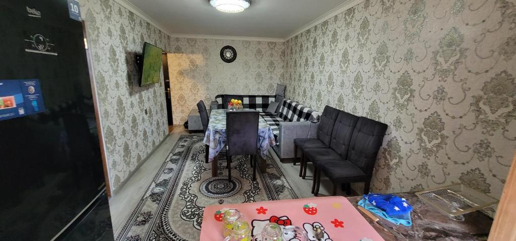 a dining room with a table and chairs at Ganja Apart in Ganja