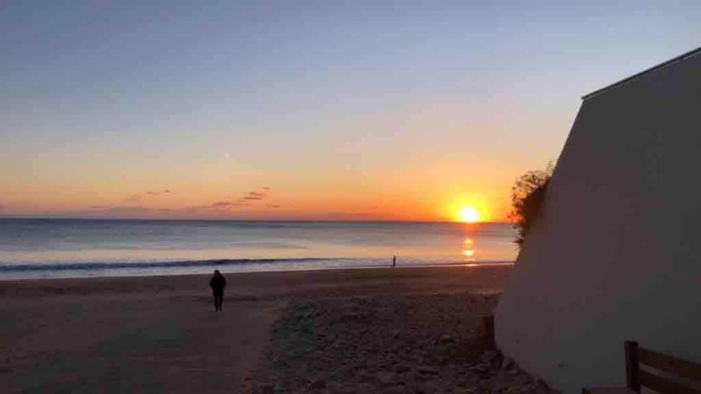 a person walking on the beach at sunset at À 100m de l ocean in Longeville-sur-Mer
