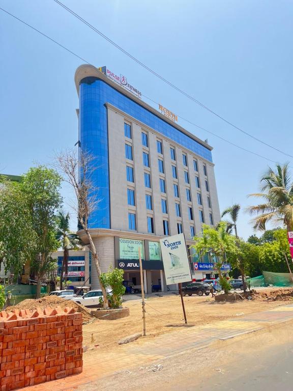 a large blue building with a sign in front of it at Hotel Sun Park Vadodara in Vadodara