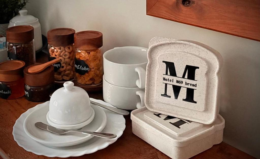 a kitchen counter with a table with a mortar and pestle and a tea pot at Motel M69 in Leicester