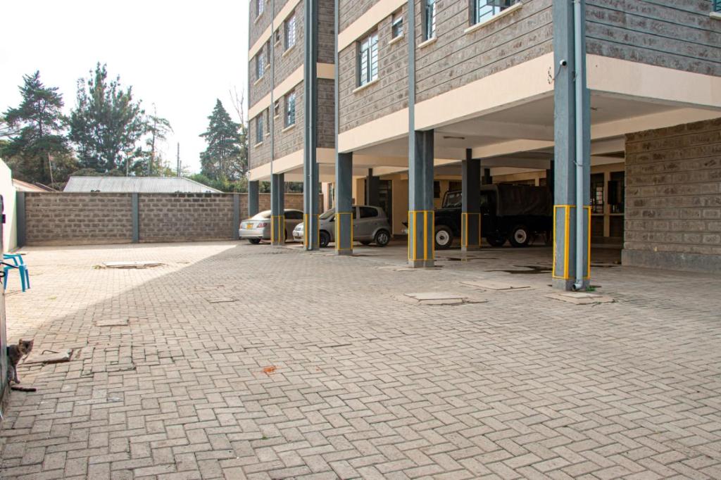 an empty parking lot in front of a building at Saagite Apartments in Ongata Rongai 