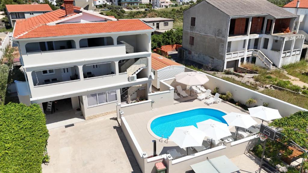 an aerial view of a house with a swimming pool at APARTMANI JAMAN in Vrsi